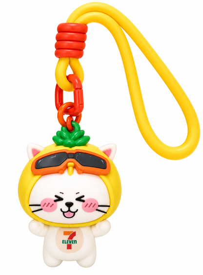 7-Eleven Vietnam Summies cat keychain with yellow helmet, orange goggles, pink cheeks, green decoration and colourful attachment on a white background.