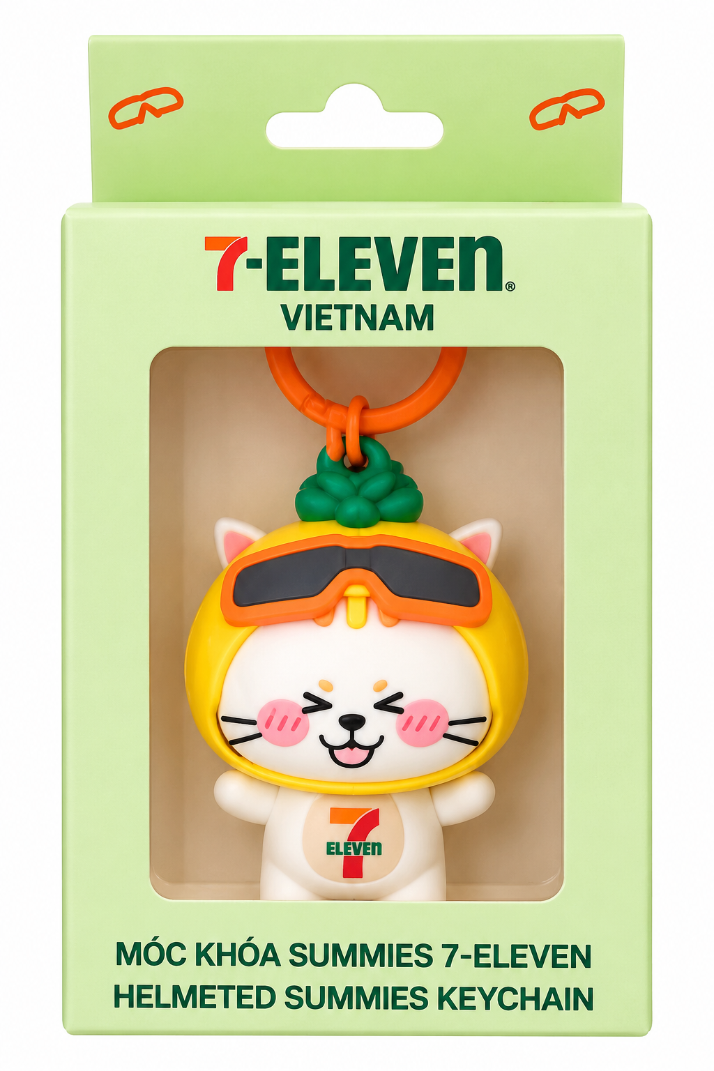 7-Eleven Vietnam Helmeted Summies collectible cat keychain in original green branded display box, featuring a yellow helmet and orange goggles.