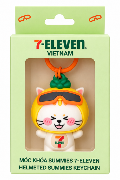 7-Eleven Vietnam Helmeted Summies collectible cat keychain in original green branded display box, featuring a yellow helmet and orange goggles.