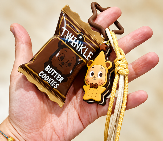 POP MART TwinkleTwinkle Little Cookie Pendant Butter Cookies bag charm with brown cookie packet, character charm and yellow cord displayed in hand
