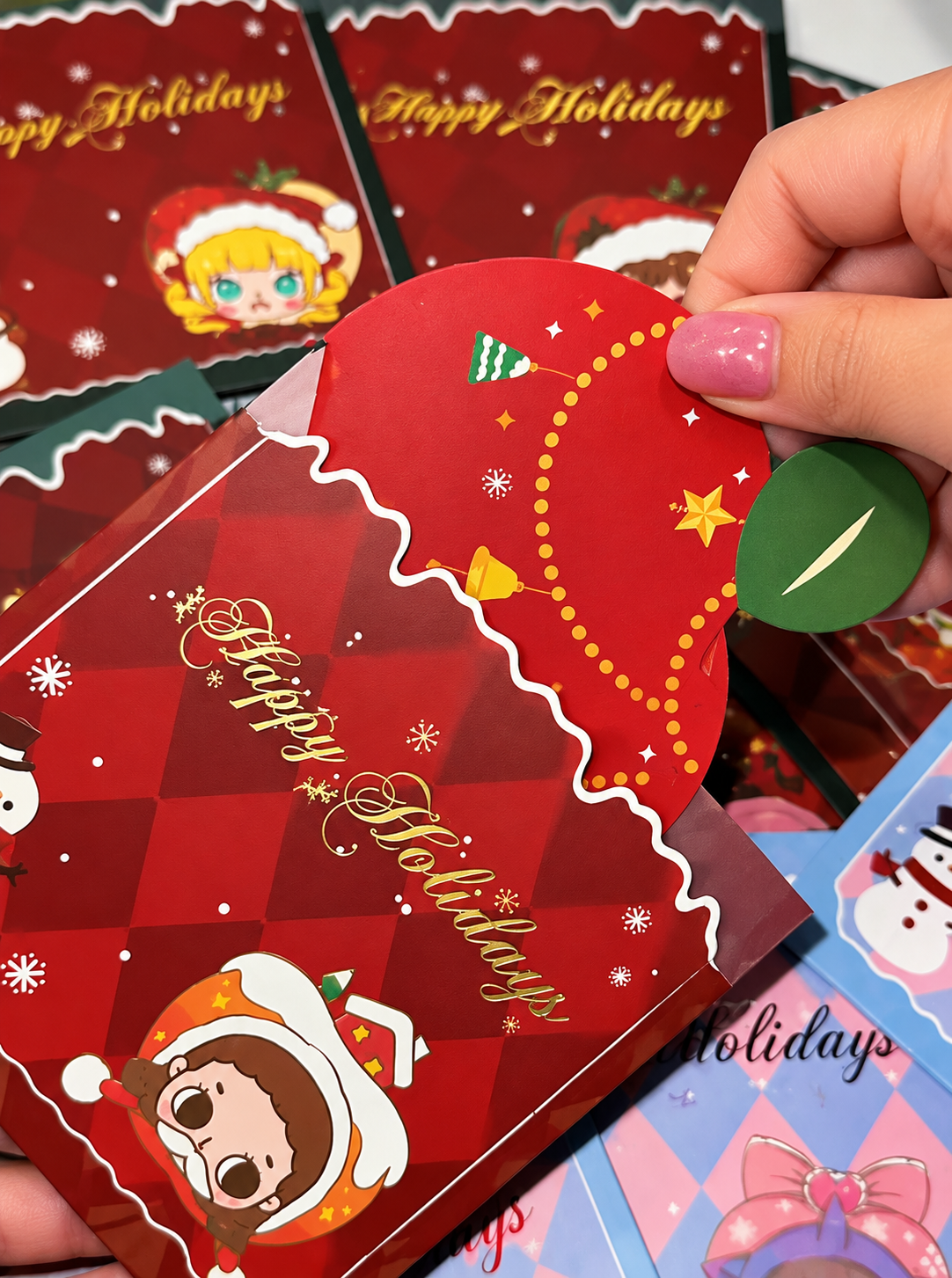 POP MART Happy Holidays Christmas greeting cards featuring festive character designs, Christmas decorations and gold lettering.