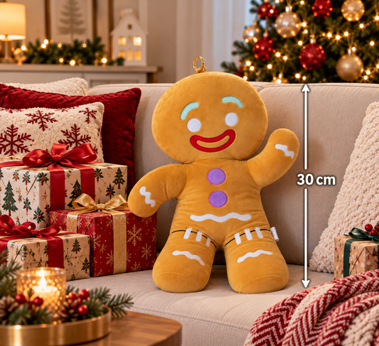 30cm Gingy Gingerbread Man Christmas plush sitting on a festive sofa surrounded by Christmas presents, cushions and a decorated Christmas tree.