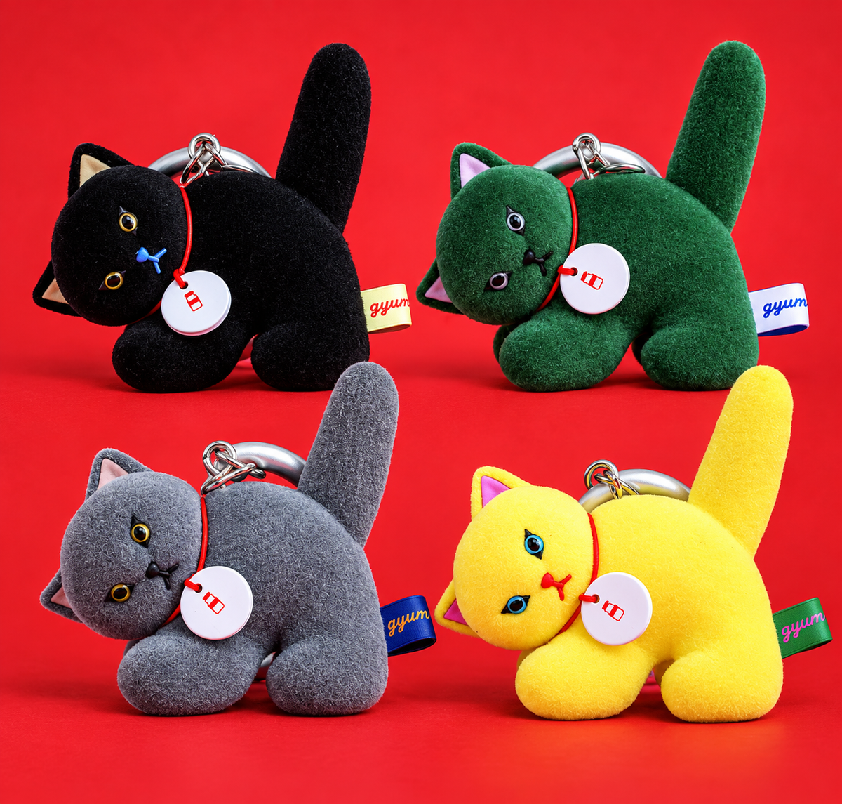 Gyunyuya Japanese designer cat mascot collection featuring four flocked cat bag charms in black, green, grey and yellow.