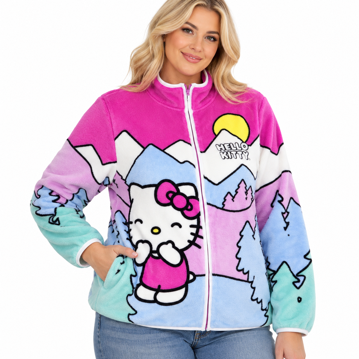 Blonde woman modelling colourful Hello Kitty mountain landscape fleece jacket with full-length zip and high collar.