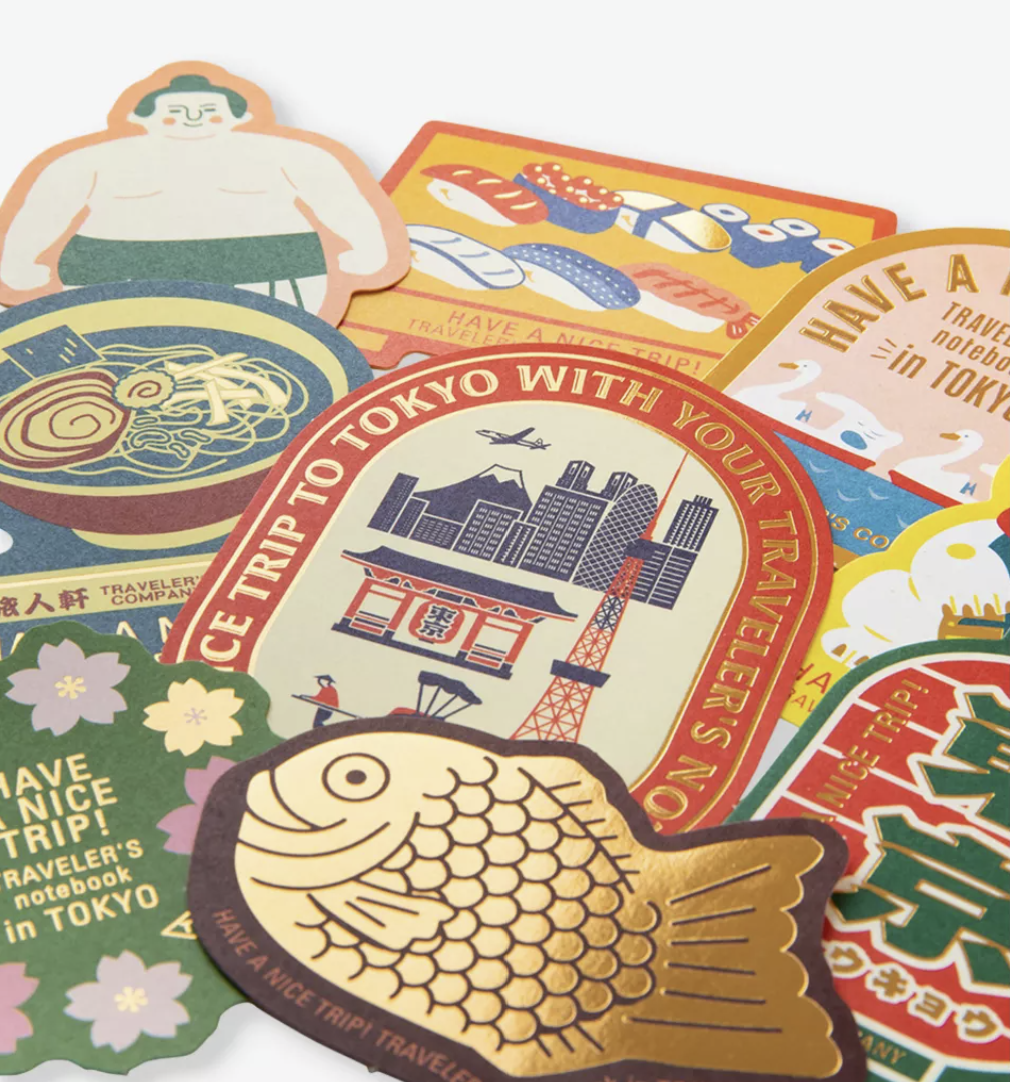 Close-up of TRAVELER'S COMPANY Tokyo Edition Japanese stickers showing detailed illustrations, vintage-inspired colours and decorative gold foil finishes.
