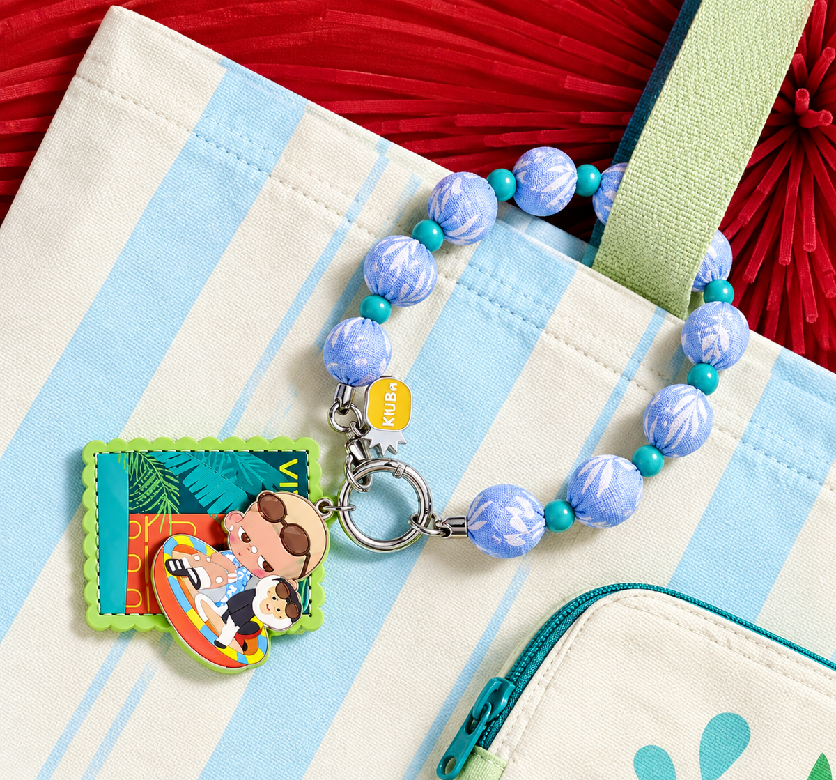 POP MART KUBO Vietnam Exclusive beaded bag charm displayed on a pastel striped handbag, showing the decorative pendant and tropical-inspired design.