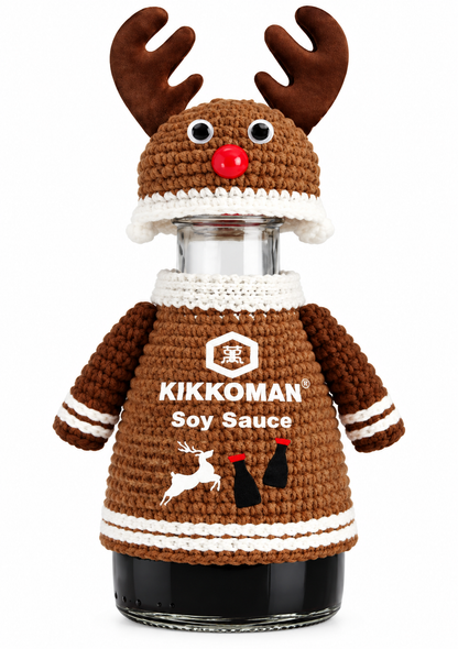 Kikkoman Christmas 2026 limited-edition reindeer soy sauce bottle featuring brown knitted-style jumper with Kikkoman branding, matching antler hat, googly eyes and red nose.