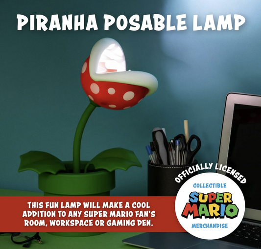 Paladone Super Mario Piranha Plant 33cm posable LED lamp illuminated on a gaming desk, featuring officially licensed Nintendo merchandise.