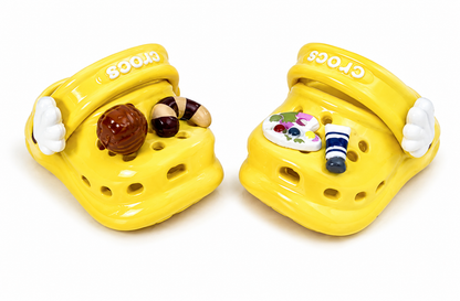 Close-up of yellow Crocs shoes and decorative charms from the Angry MOLLY x Crocs Angry Cheese figure