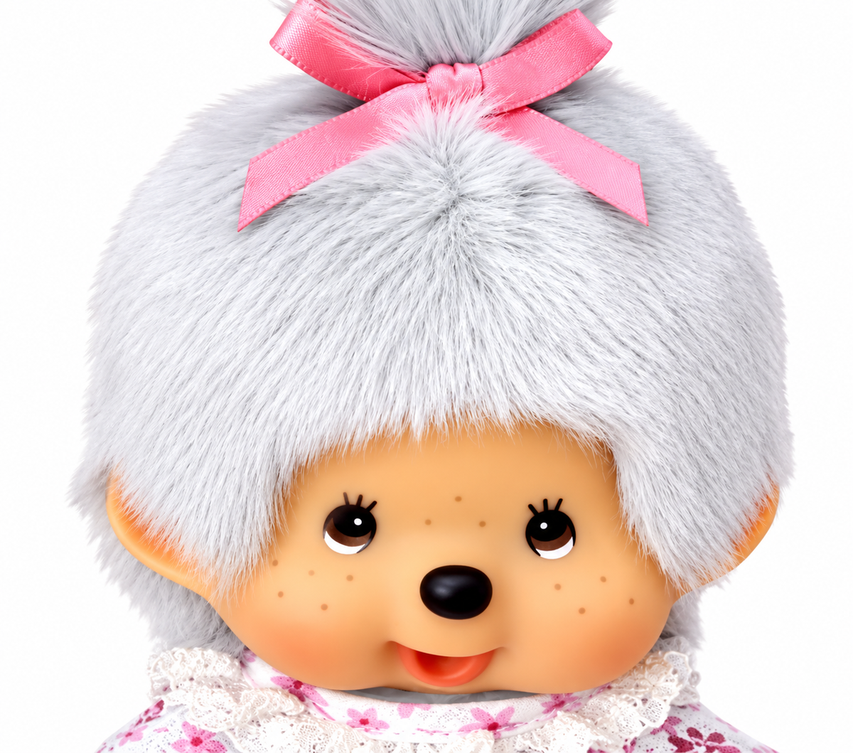 Close-up of Sekiguchi Monchhichi Grandma plush with grey hair, pink bow and classic Monchhichi face