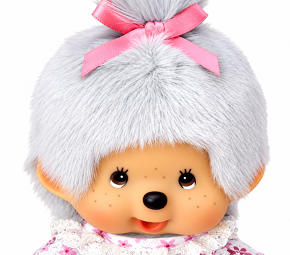 Close-up of Sekiguchi Monchhichi Grandma plush with grey hair, pink bow and classic Monchhichi face