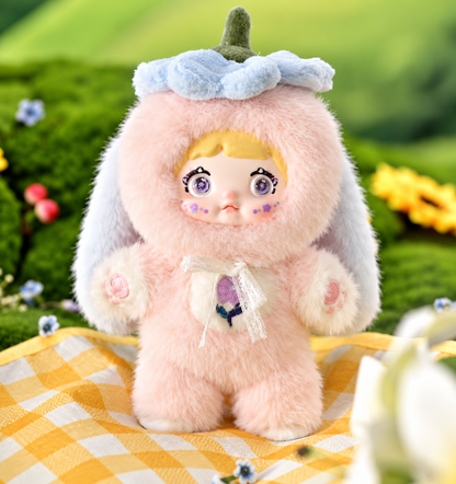 Nommi Garden Rabbit Campanula vinyl face plush doll wearing a fluffy pastel pink bunny outfit with purple eyes, long floppy ears and floral detailing.