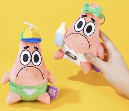 Pop Mart × SpongeBob SquarePants Friends Play Together Patrick Star collectible plush keychains featuring two designs, including Patrick wearing a propeller hat and Patrick with a green bow, displayed against a yellow background.