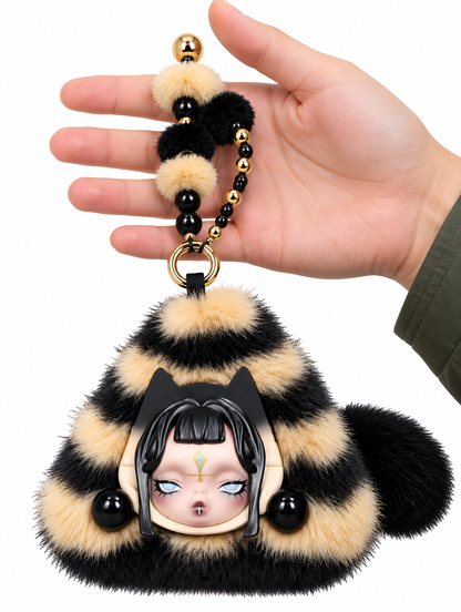 SKULLPANDA Mystic Veil Mini Bag held against a hand to demonstrate its size, featuring fluffy striped fabric and black and gold beaded strap.