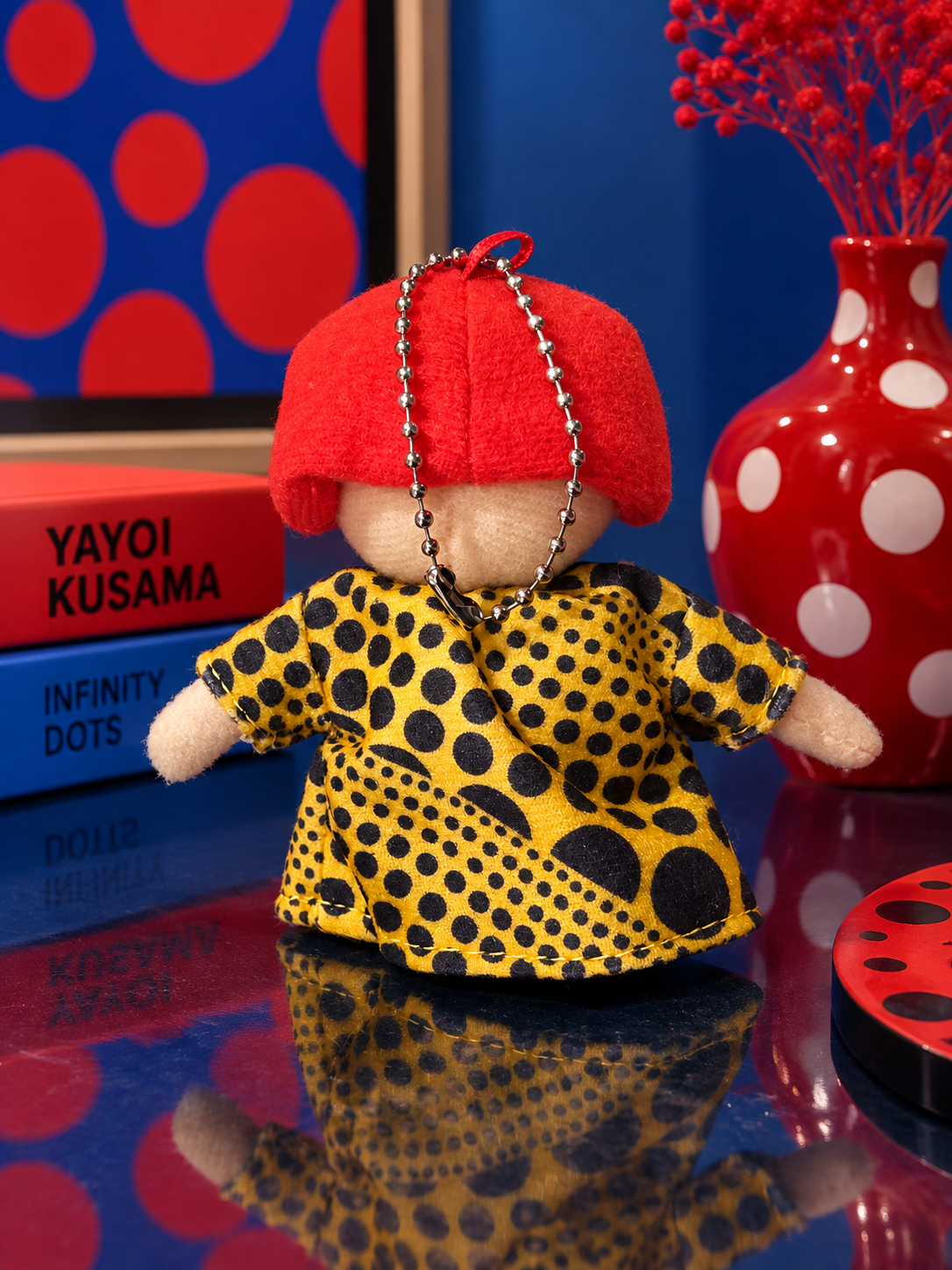 Back view of Yayoi Kusama custom plush keychain with red hair and yellow polka dot dress