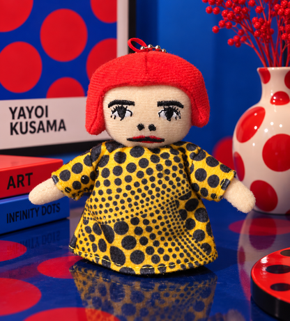 Custom-made Yayoi Kusama plush doll with red hair against blue and red polka dot art background
